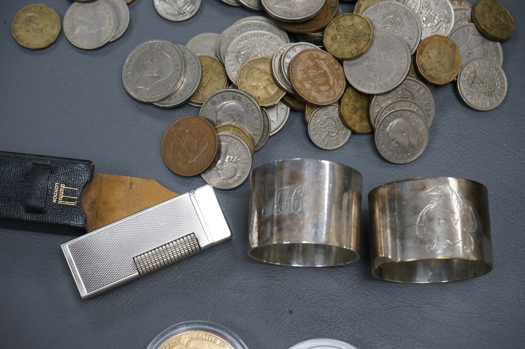 Sundry items comprising a cased Dunhill lighter, coins and napkin rings